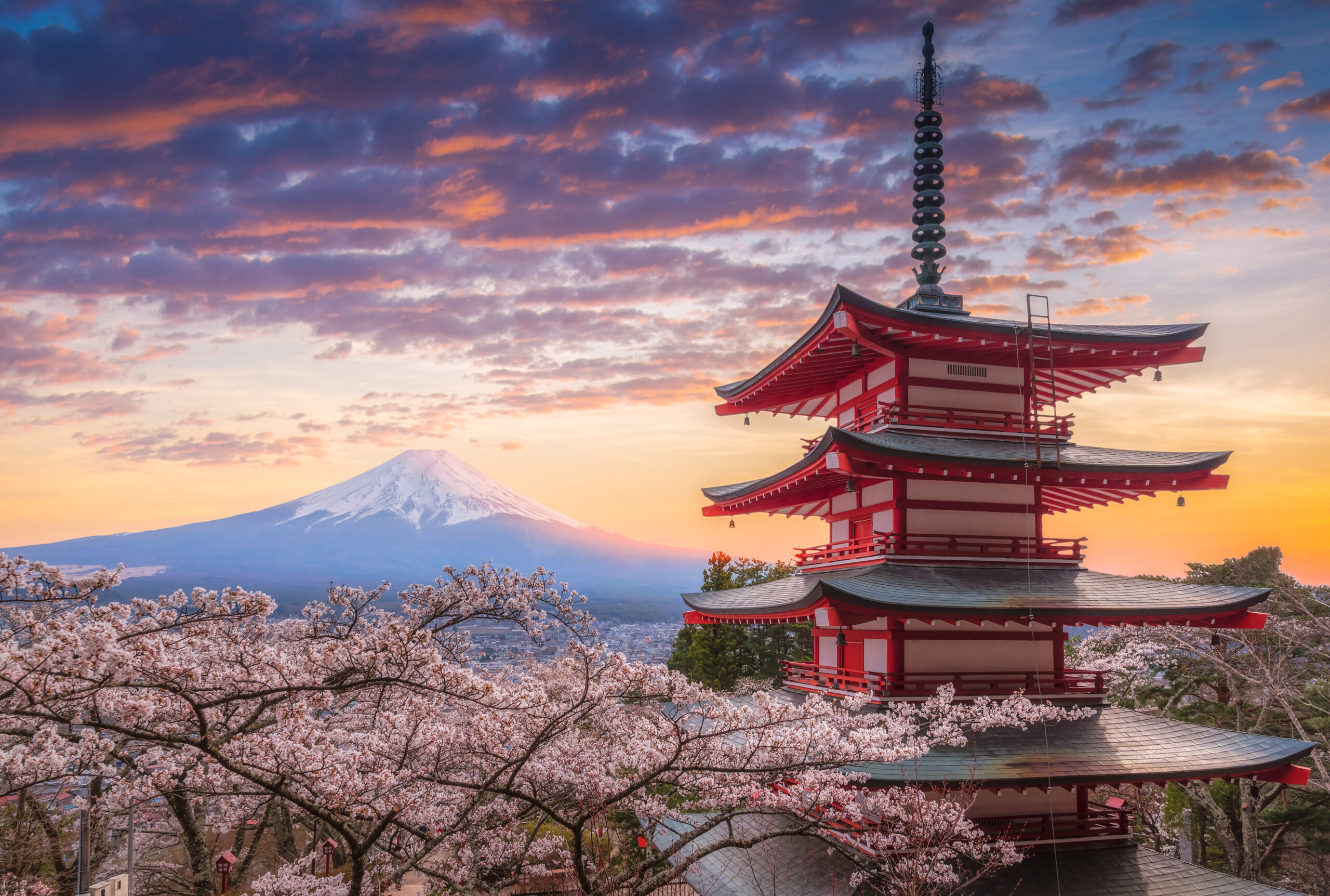 Mount Fujisan beautiful landscapes on sunset. Fujiyoshida, Japan at Chureito Pagoda and Mt. Fuji in the spring with cherry blossoms.